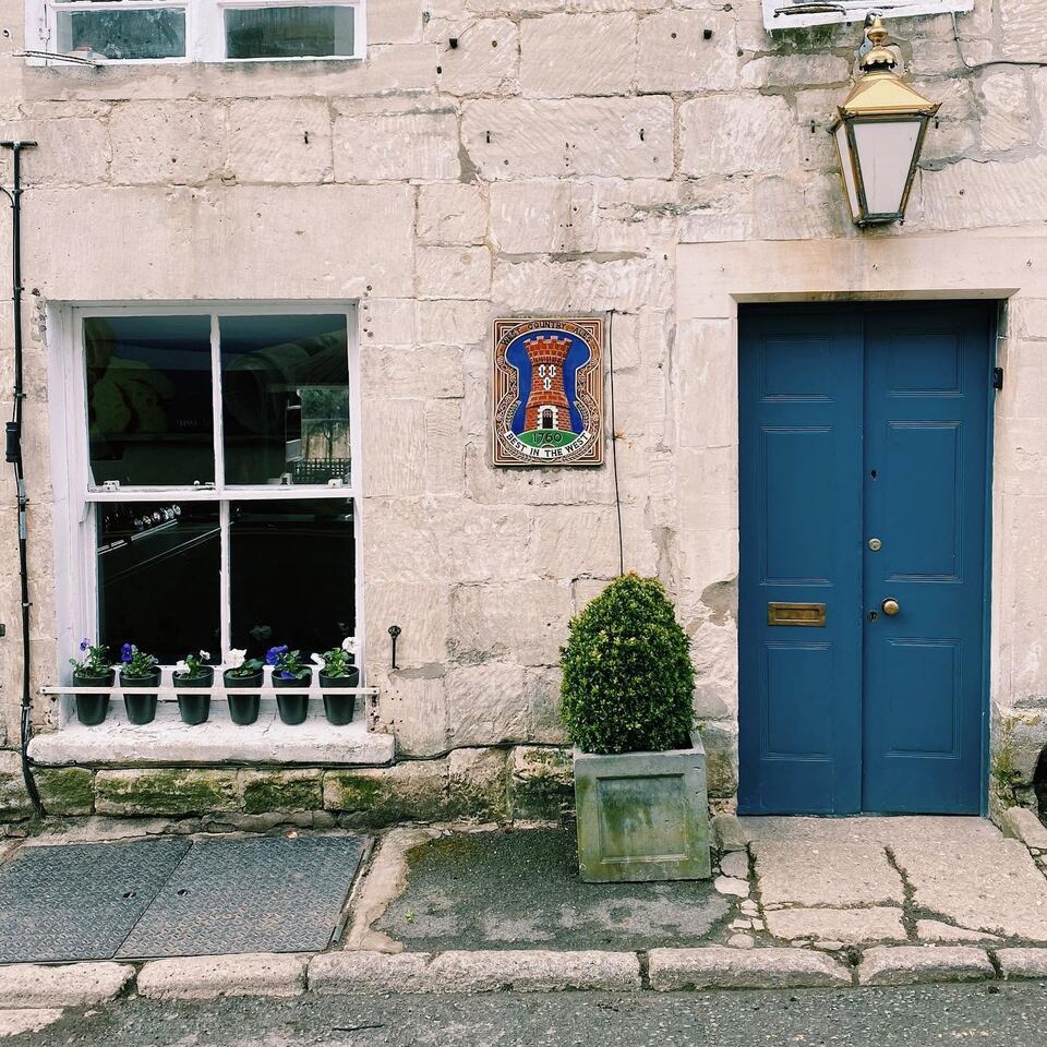 The Oak's stone frontage on St Mary's Street, with its blue door and brass lantern